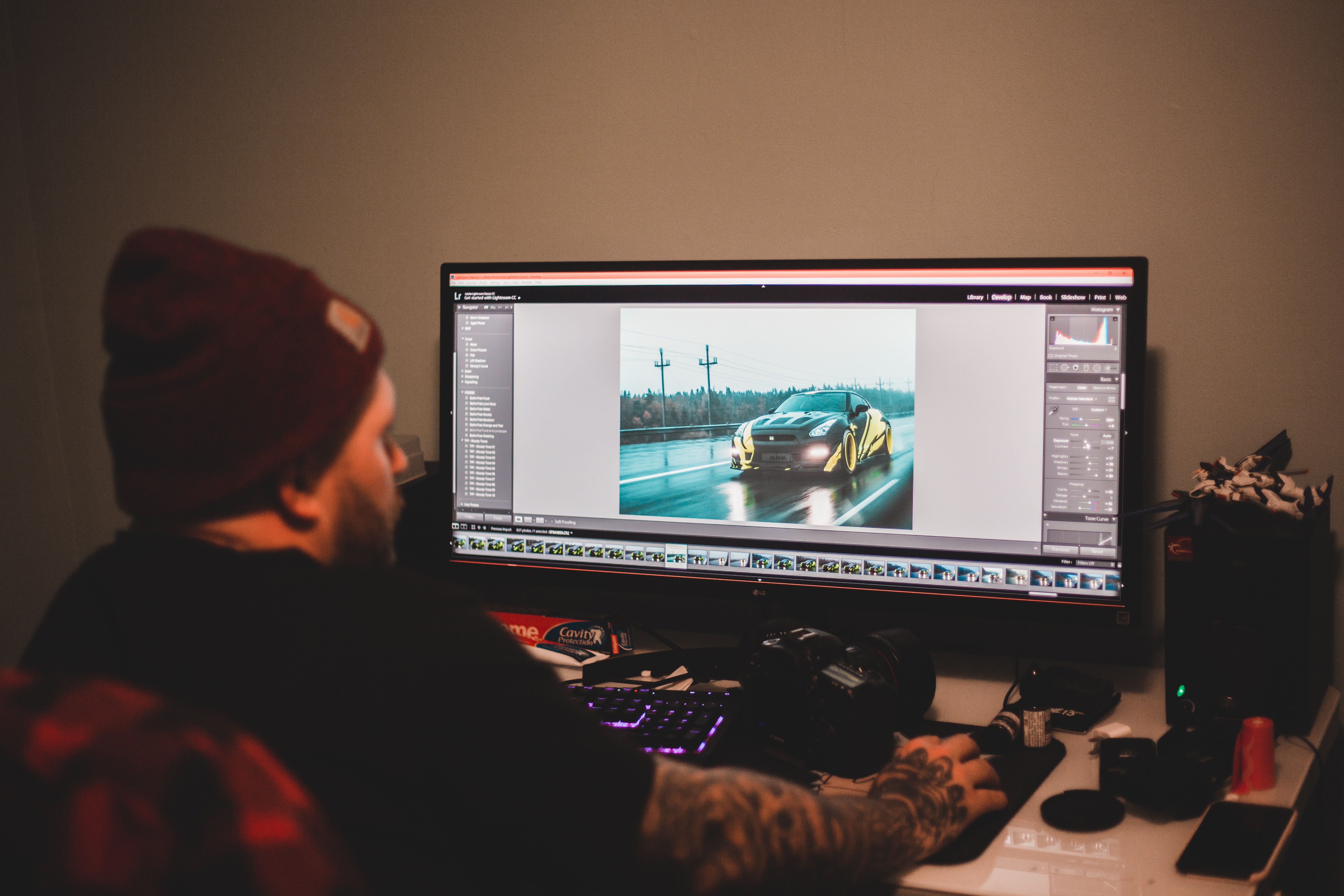 person in beanie editing video on desktop