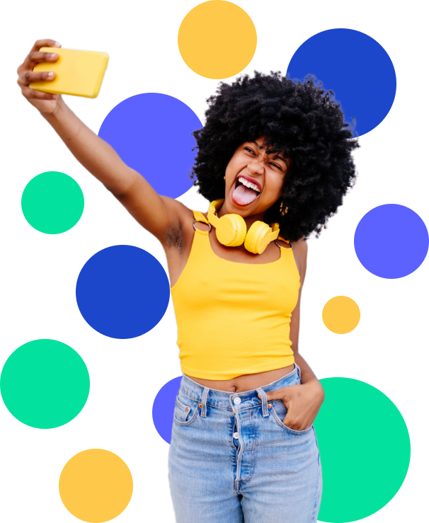 Woman in yellow taking selfie with phone